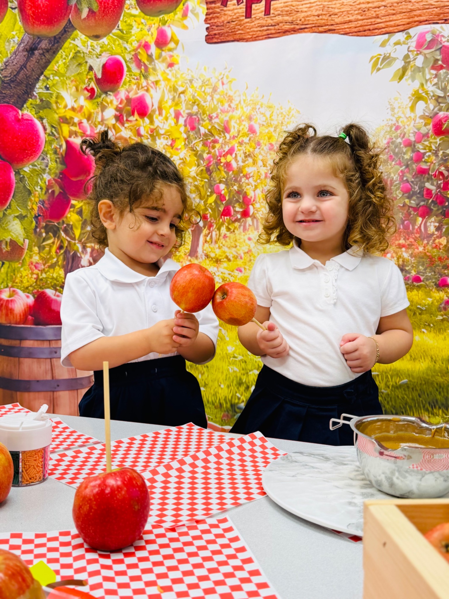 Young children exploring apples during a classroom activity