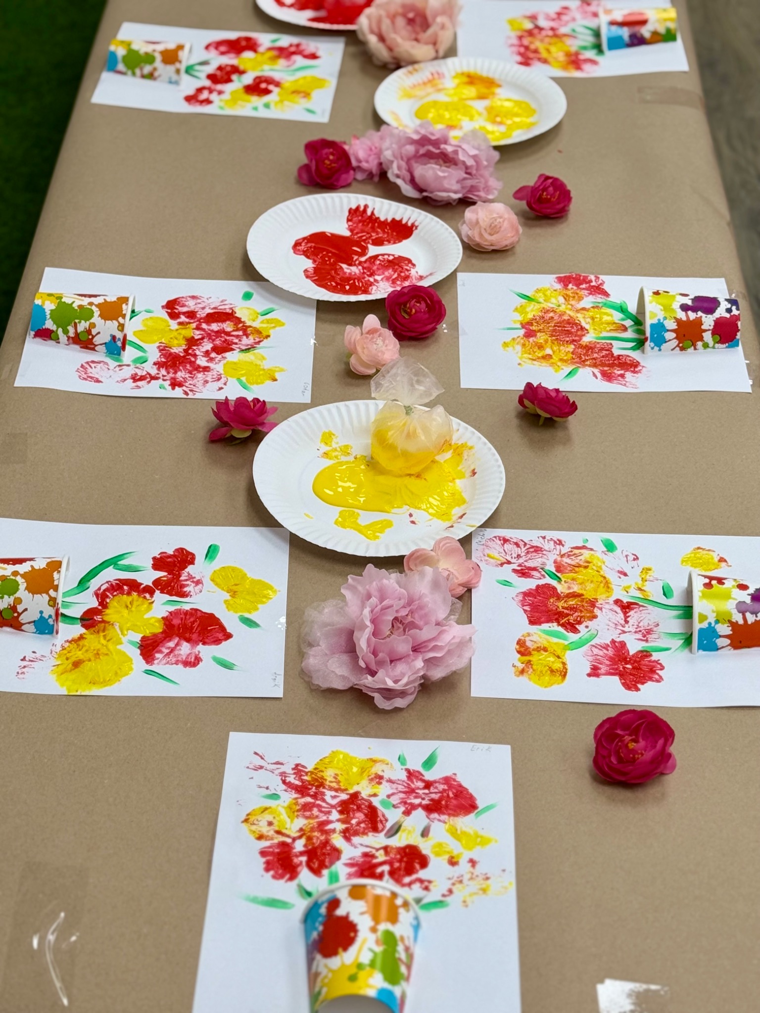 Children’s colorful artwork arranged on a classroom table