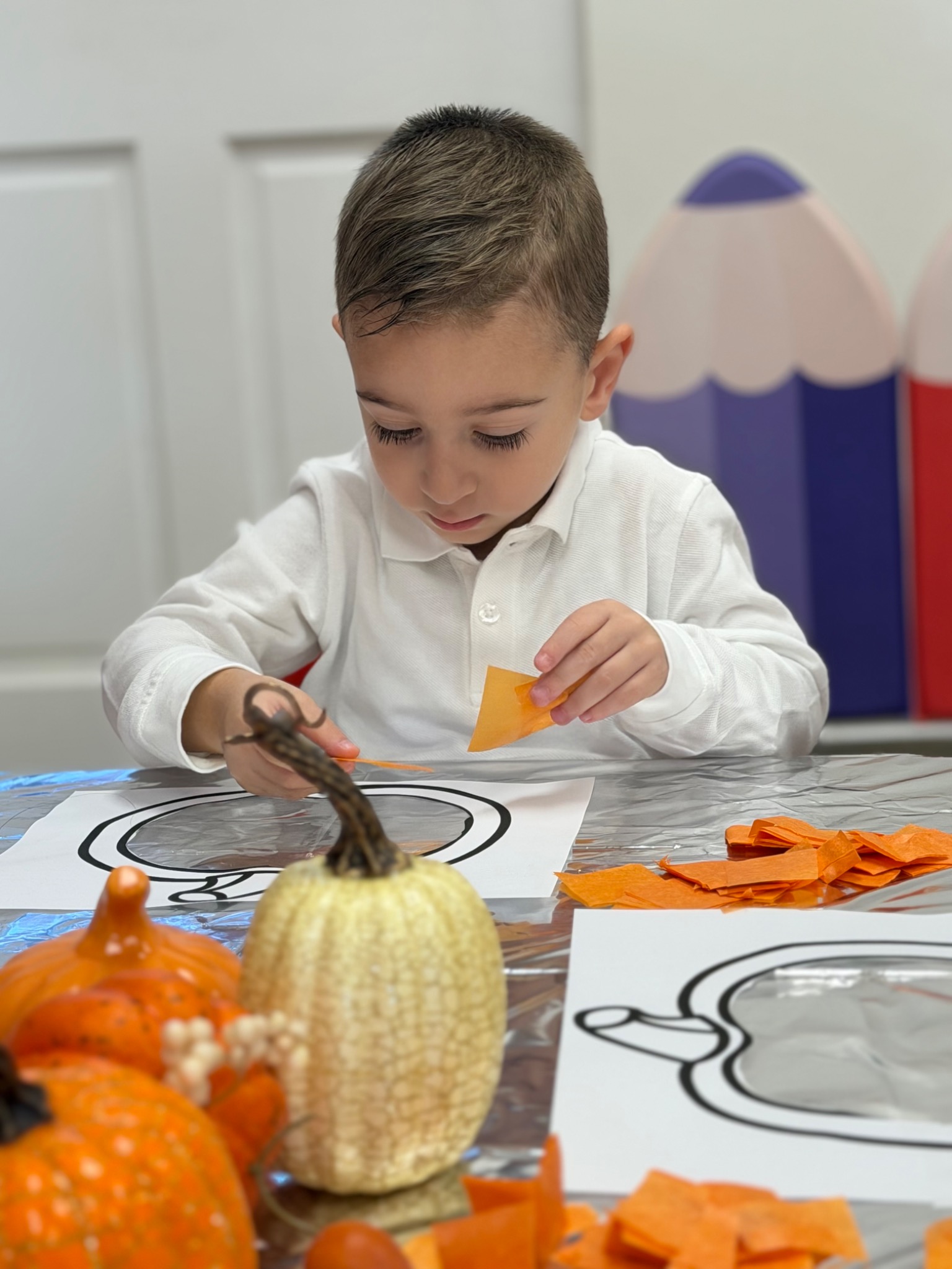 A young child practicing fine-motor skills through art