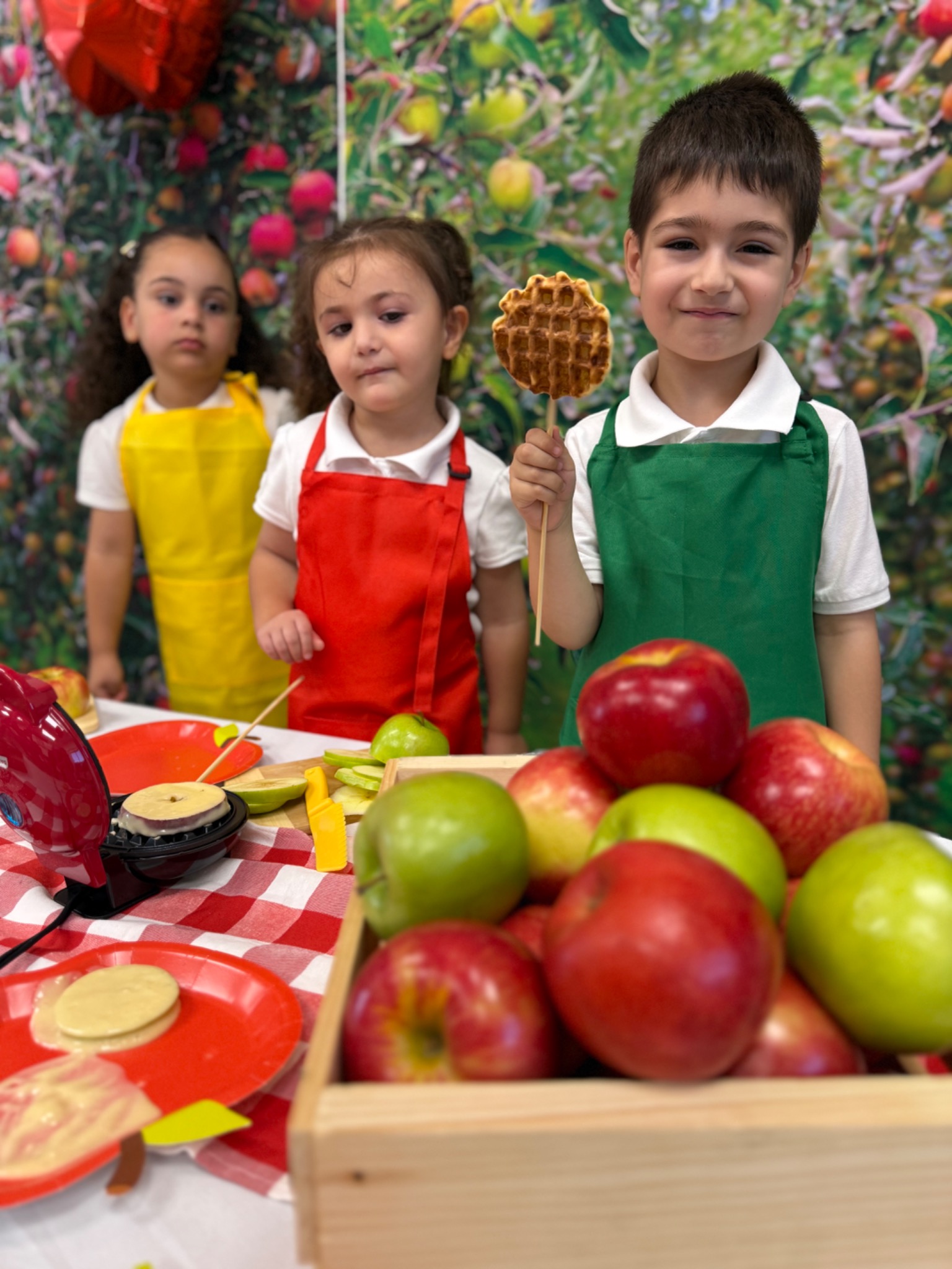 Preschool children exploring apples together during a practical-life classroom activity