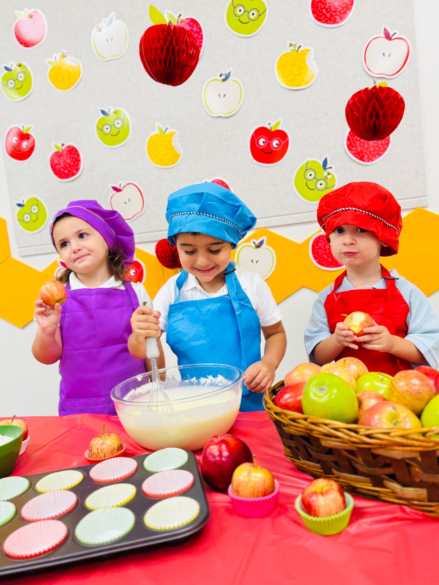 Preschool children mixing ingredients together during a hands-on baking activity