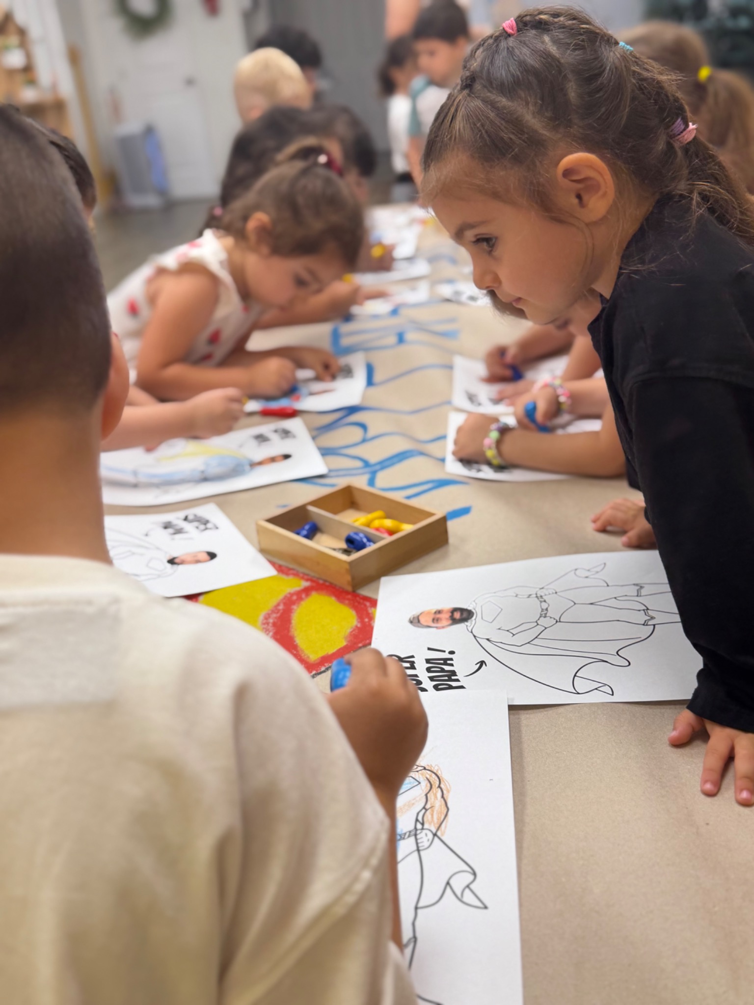 Preschool children participating in a small-group literacy lesson with classroom materials
