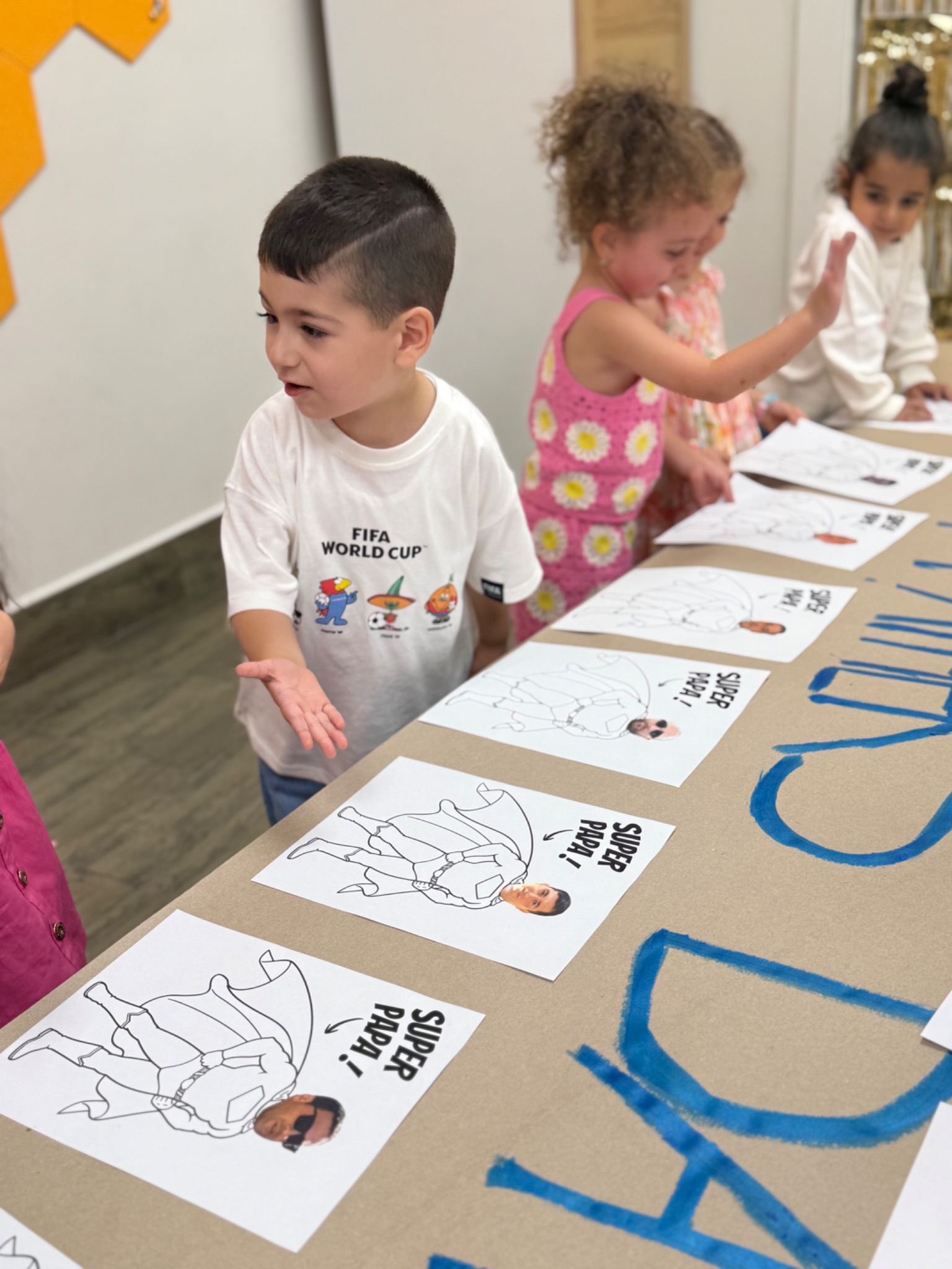 A preschool child completing an early-literacy activity independently at a classroom table