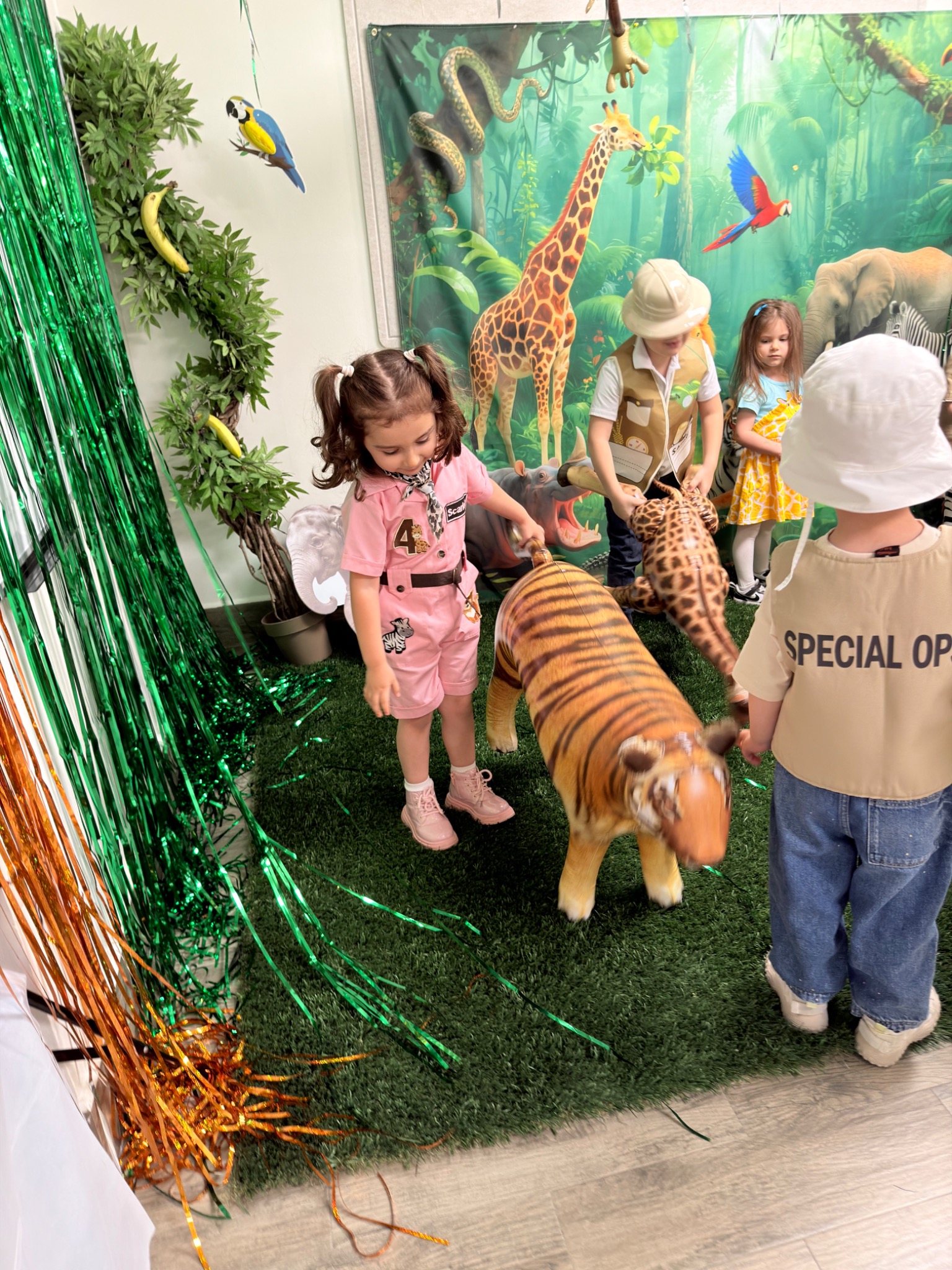 Preschool children exploring animals and plants in an outdoor nature-learning area