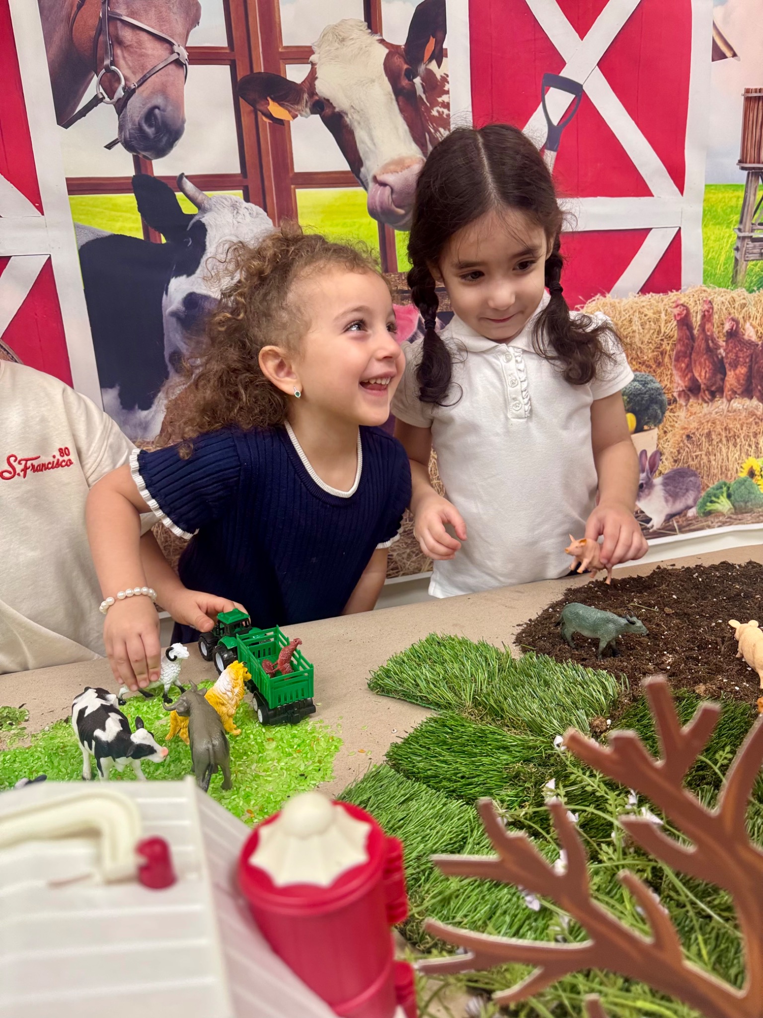 Preschool children exploring a hands-on farm-themed sensory learning activity