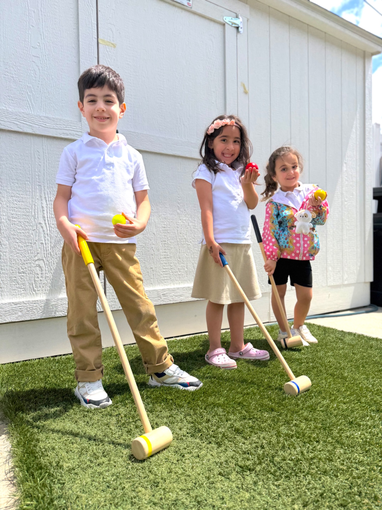 Kindergarten students developing coordination through an outdoor croquet activity