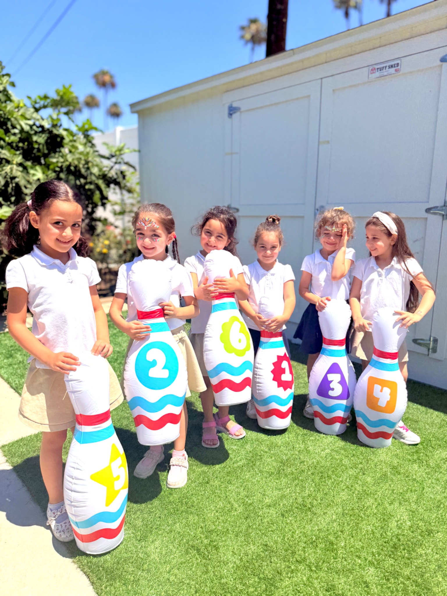 Kindergarten students practicing numbers through a colorful outdoor movement game